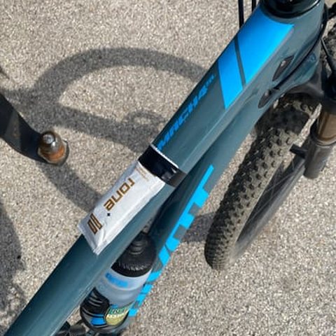 RONE sachet taped to a bike top tube