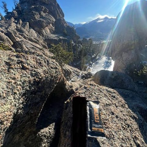 RONE sachet on a rock above a mountain lake