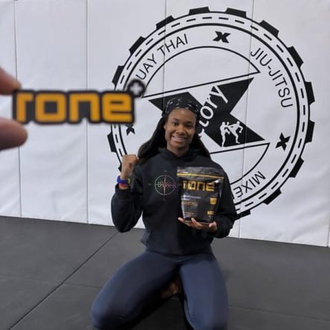 MMA fighter holding RONE in the gym